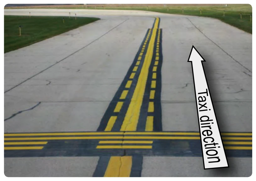 Runway holding position markings as seen when exiting the runway. When exiting the runway, no ATC clearance is required to cross.
