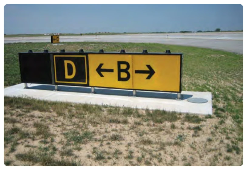 Taxiway Bravo direction sign with a collocated Figure 14-23. Figure 14-23 Taxiway Delta location sign. When the arrow on the direction sign indicates a turn, the sign is located prior to the intersection.