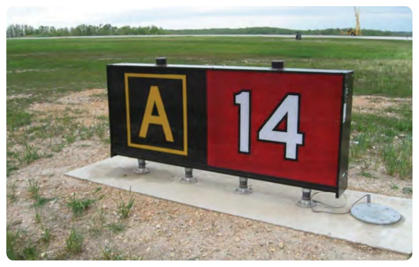 Runway holding position sign at takeoff end of Runway 14 with collocated Taxiway Alpha location sign.